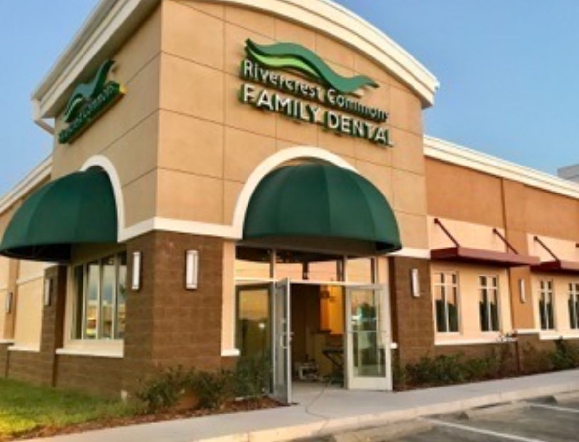 Riverside Commons Family Dental building with green awnings and signage.