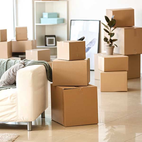 Furniture, belongings and moving boxes in room 
