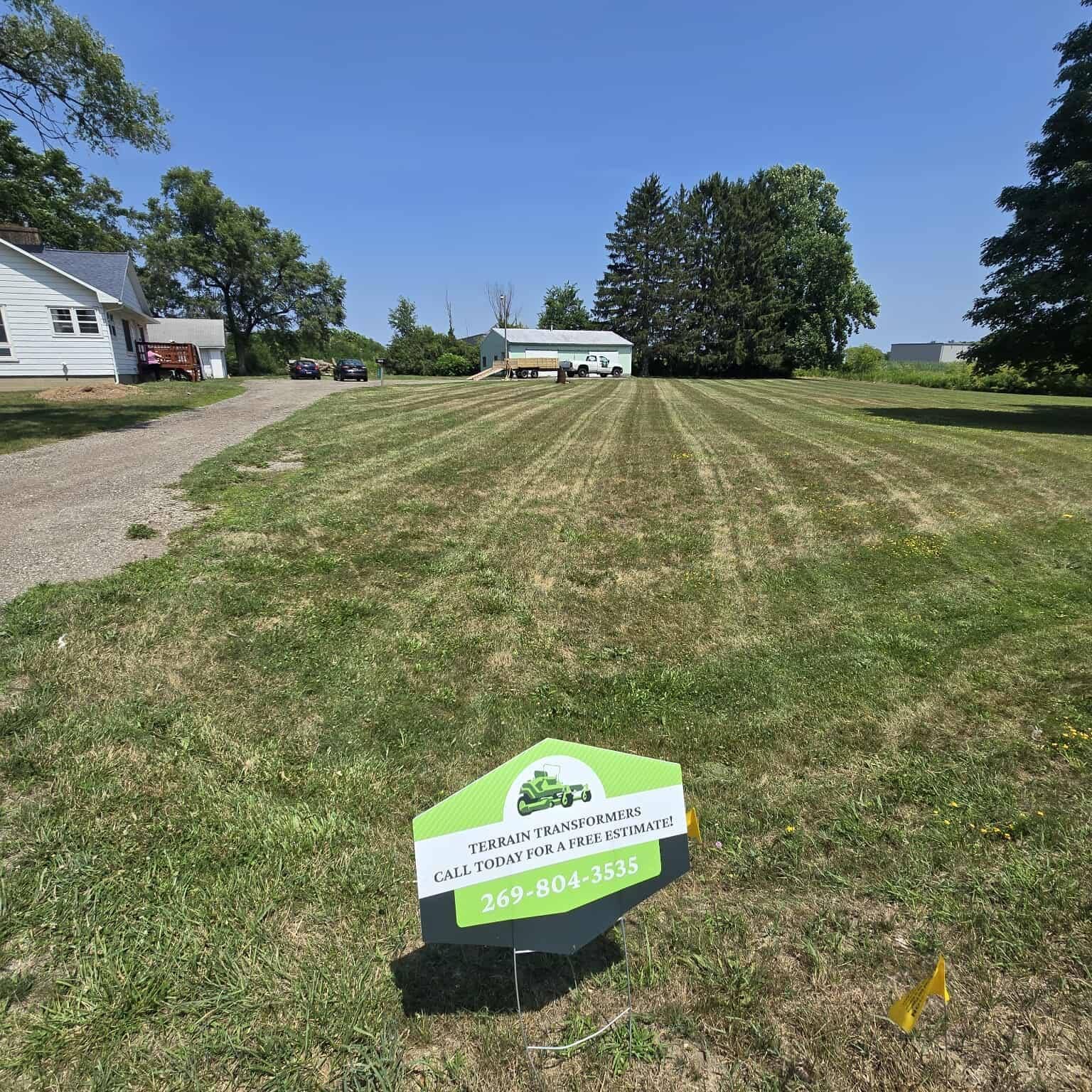 A yard with a sign that says ' lawn maintenance ' on it