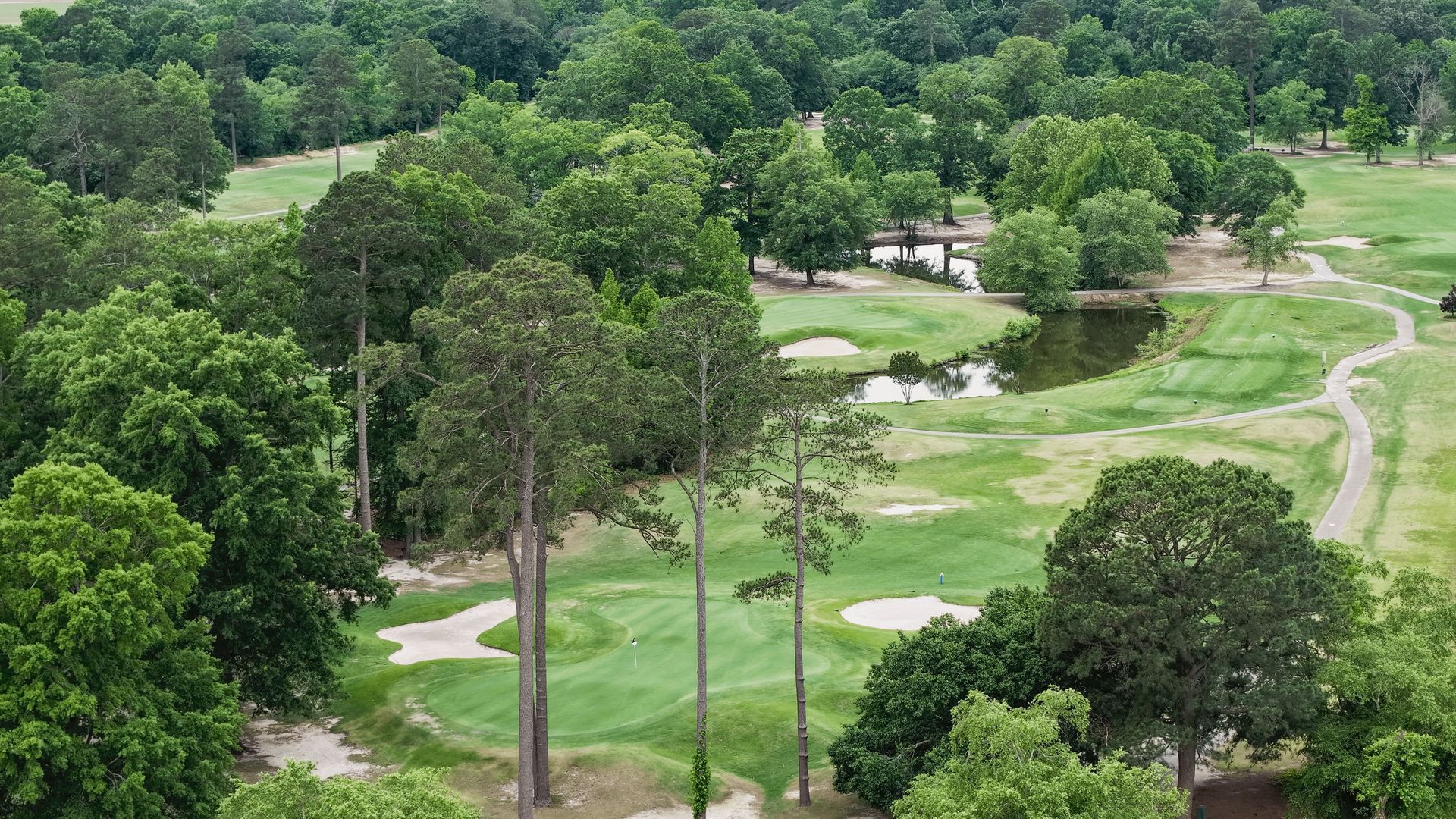An aerial view of a golf course with a circle in the middle. An aerial view of a golf course with a circle in the middle.