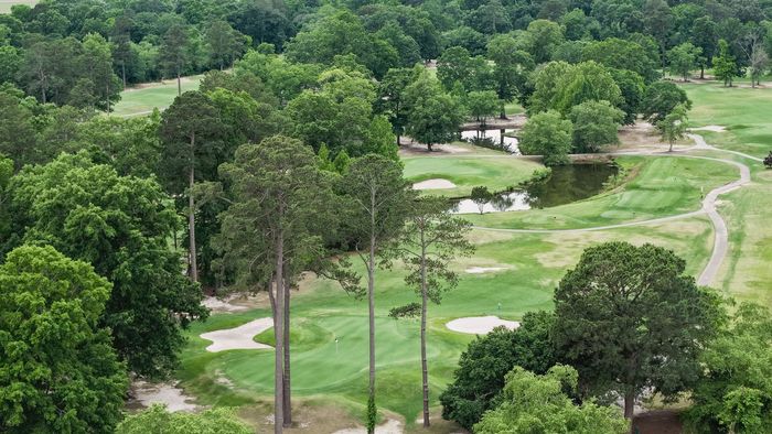 An aerial view of a golf course with a circle in the middle. An aerial view of a golf course with a circle in the middle.