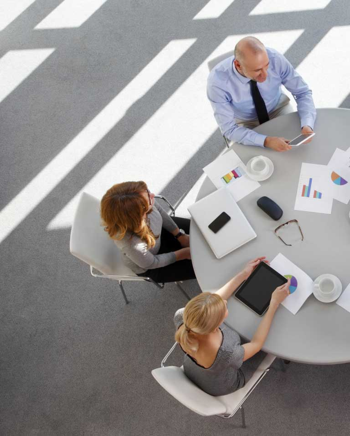 A team seated beside a round table