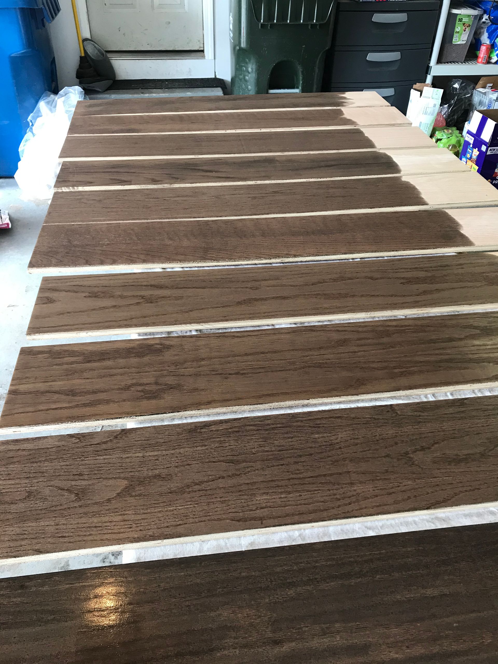 Brown-painted wooden planks with white stripes in a garage setting.