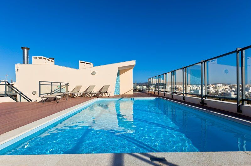 tall glass fence next to pool