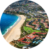 An aerial view of a beach and a city in a circle