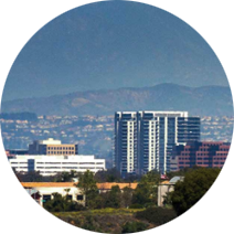 A circle of buildings with mountains in the background