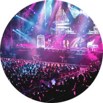A crowd of people are standing in front of a stage at a concert.