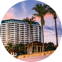 A large building with palm trees in front of it