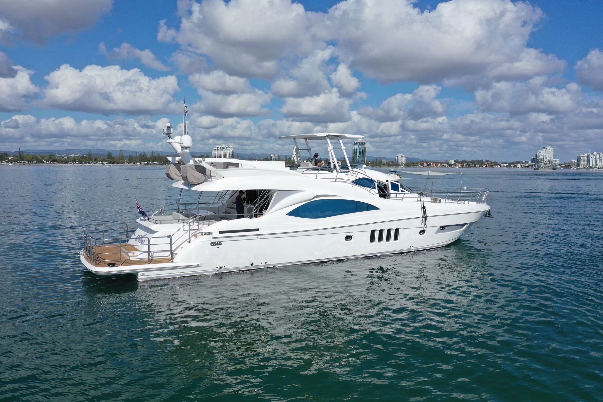 A large white yacht is floating on top of a body of water.