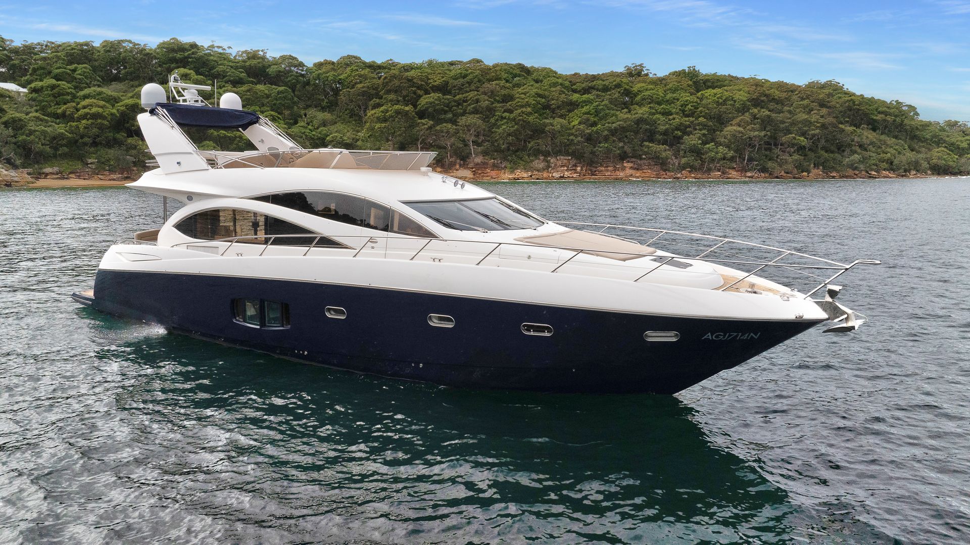 A large yacht is floating on top of a body of water.