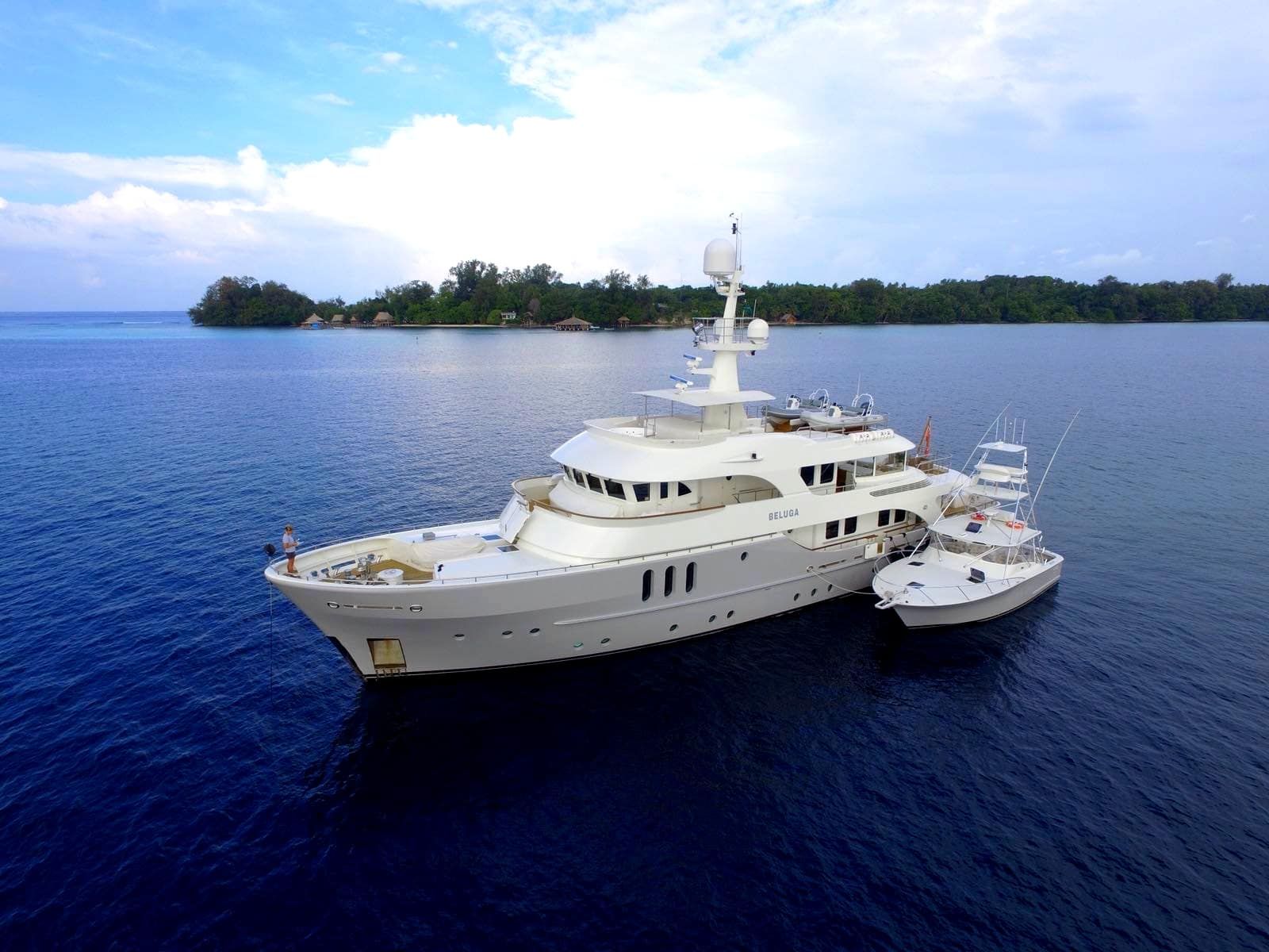A large white yacht is floating in the ocean