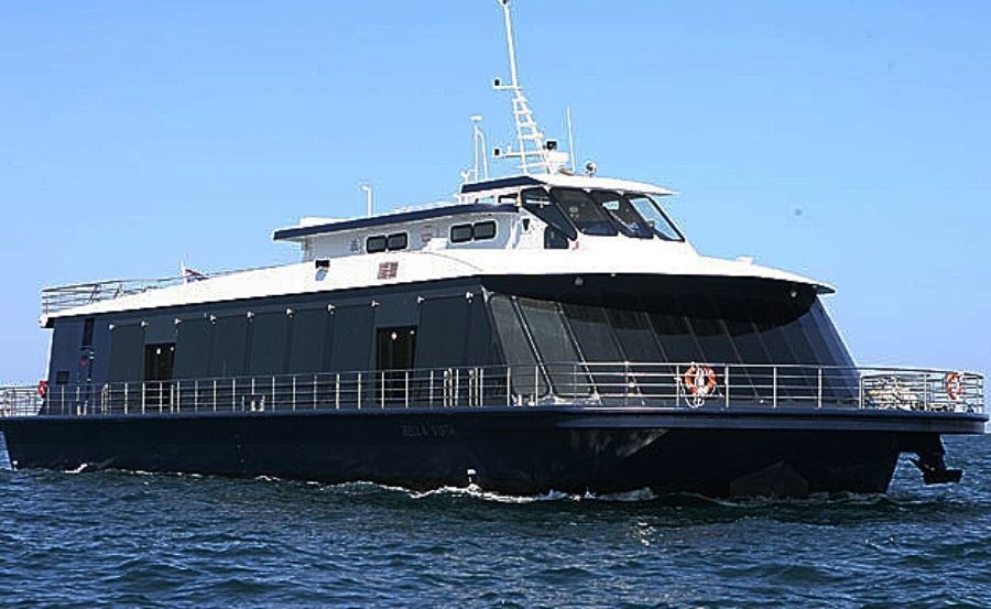 A boat in the water with a city skyline in the background