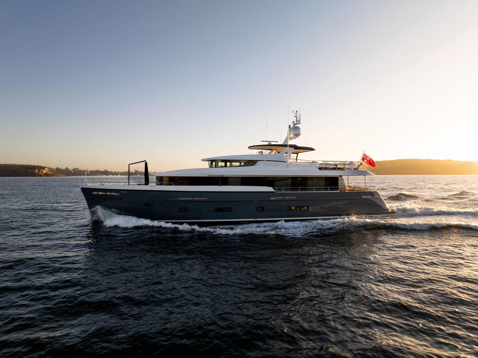 A large yacht is floating on top of a body of water.