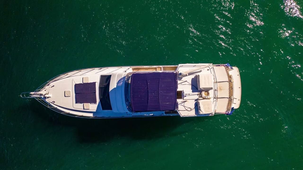A large white boat is floating on top of a body of water.