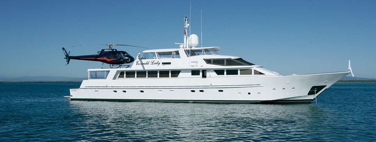 A large white yacht is floating on top of a body of water.