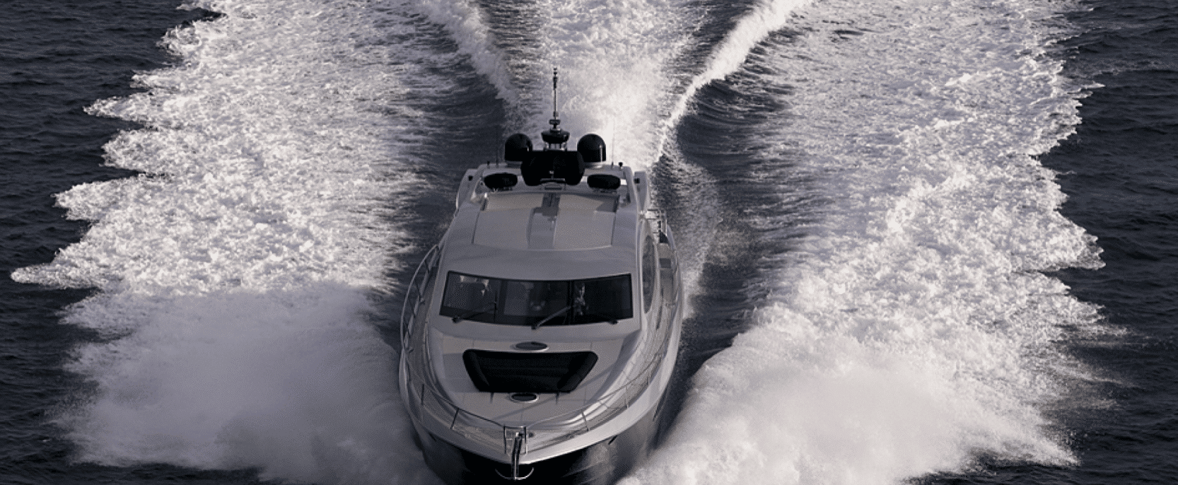A large yacht is floating on top of a body of water