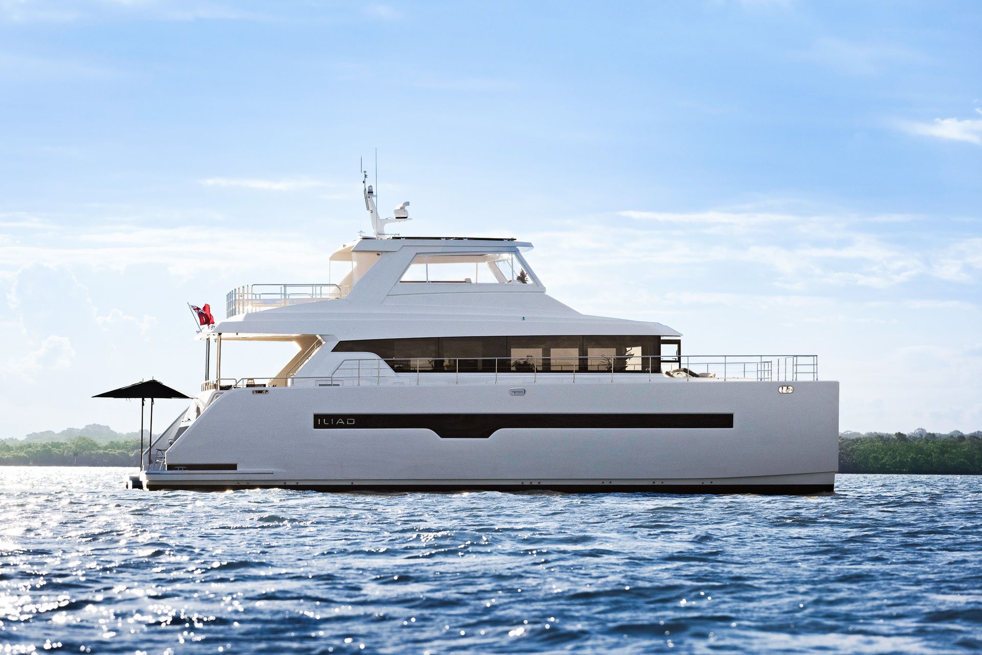 A large white yacht is floating on top of a body of water.