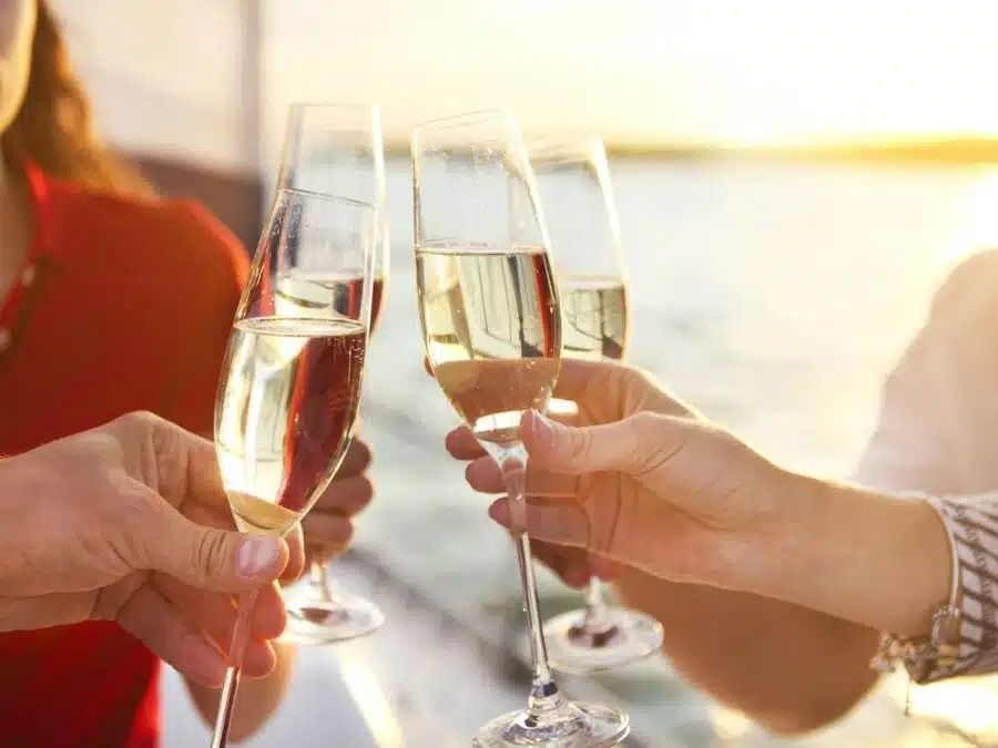 Guest With Glasses Of Champagne On Yacht