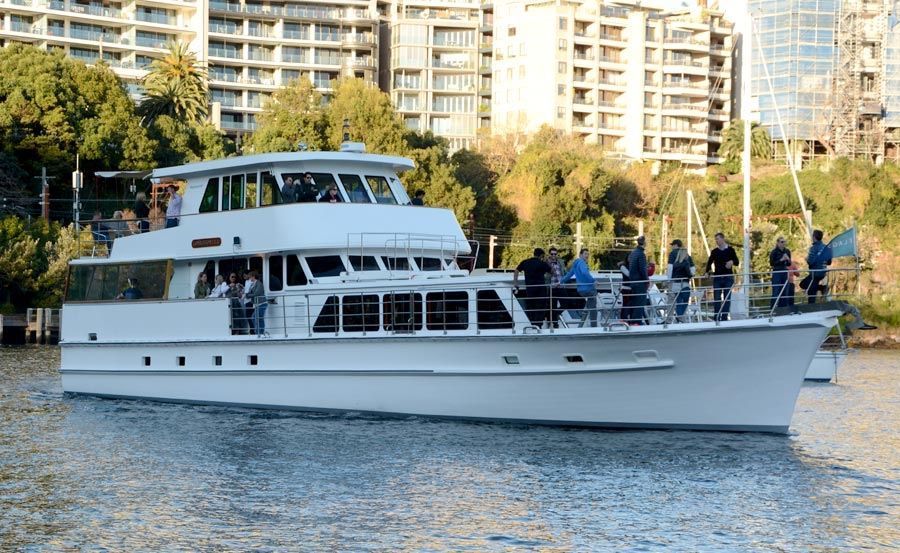A large white boat is floating on top of a body of water.