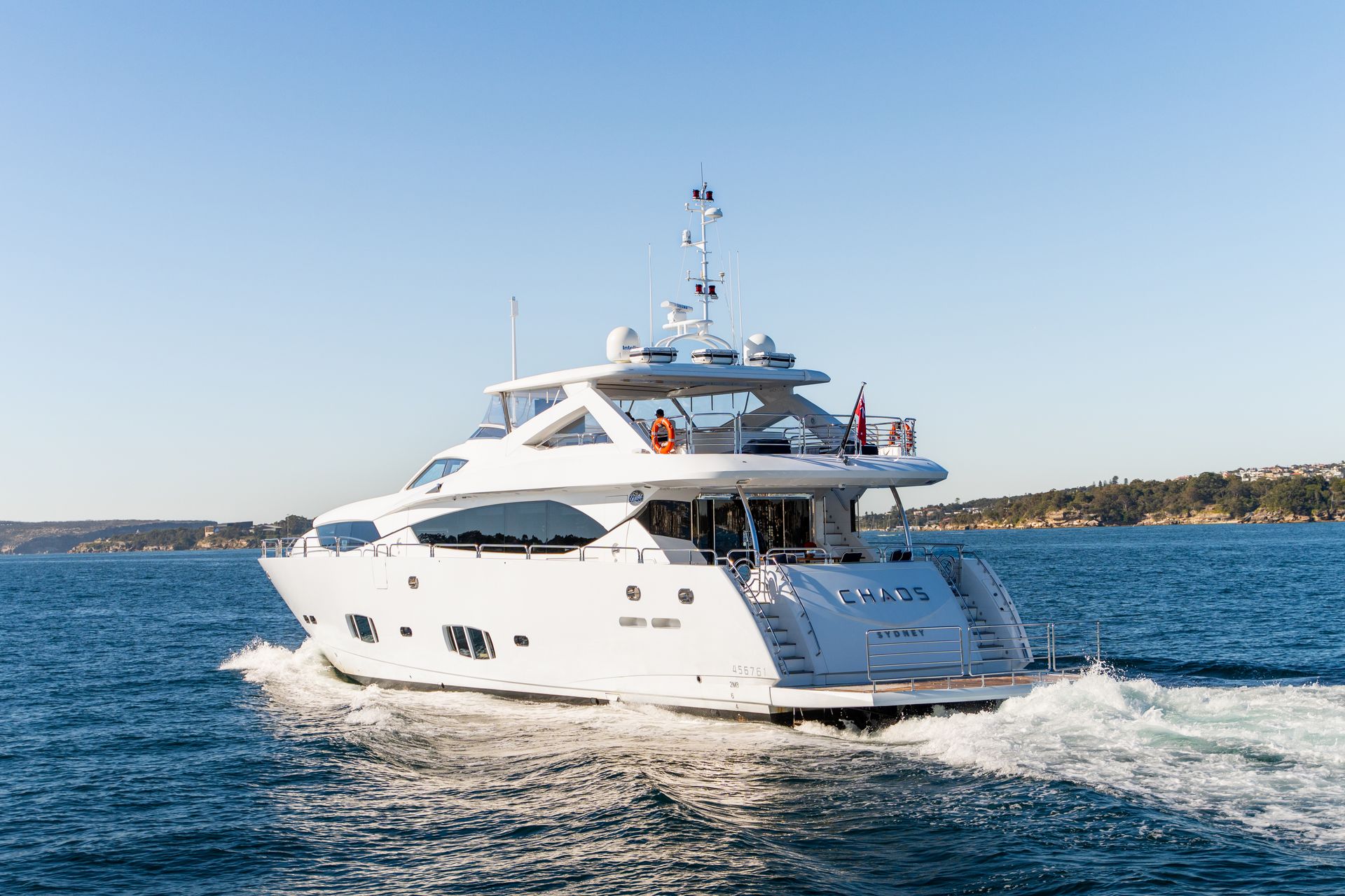A large white yacht is floating on top of a body of water.