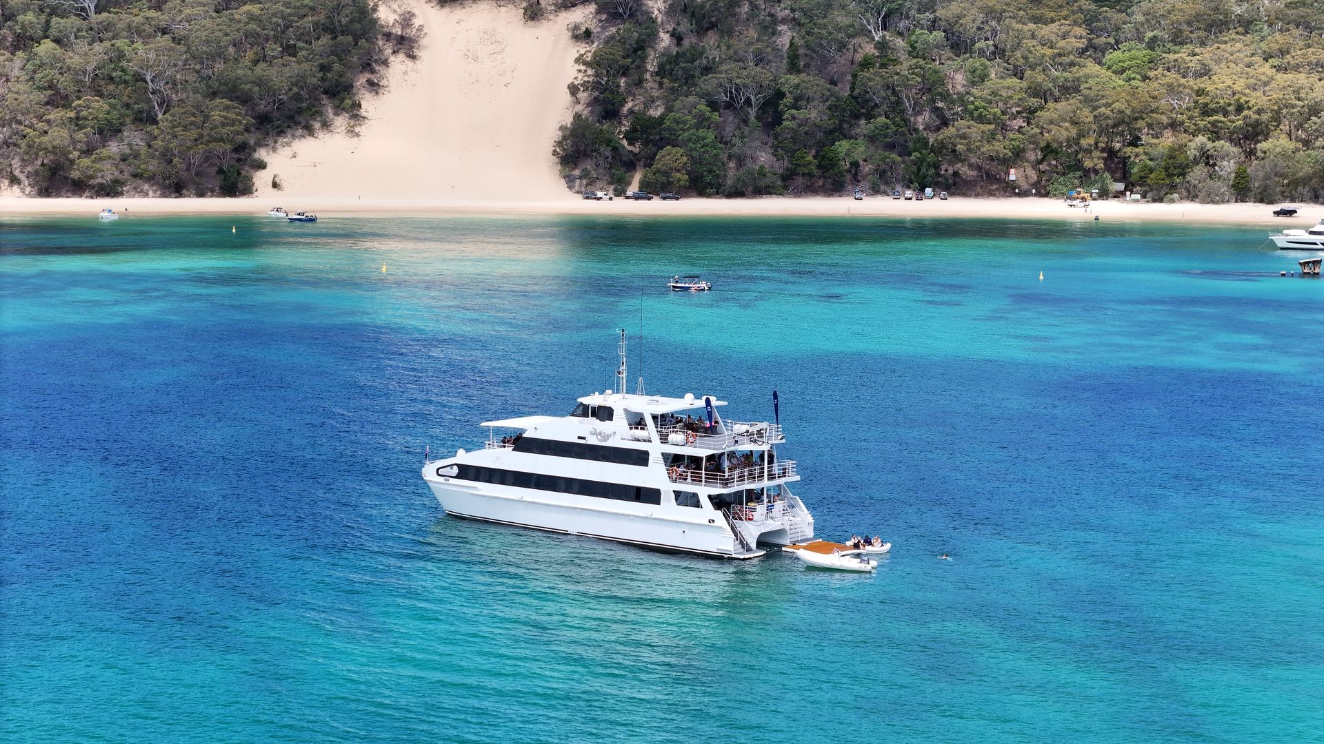 A large white boat is floating on top of a body of water.