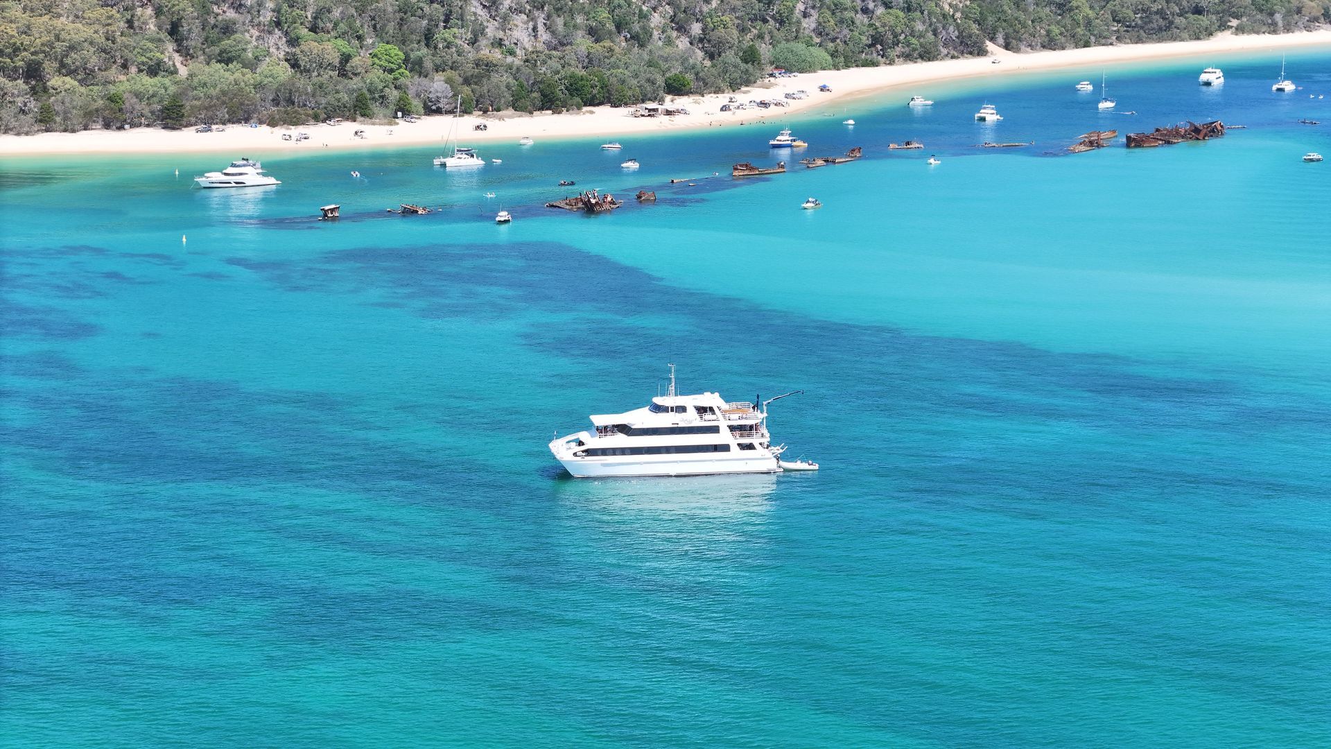 A large white boat is floating on top of a body of water.