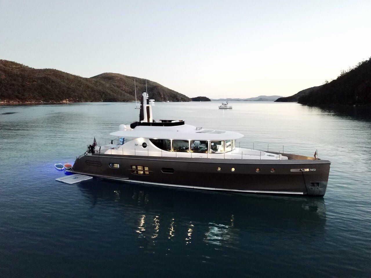 A large yacht is floating on top of a body of water.