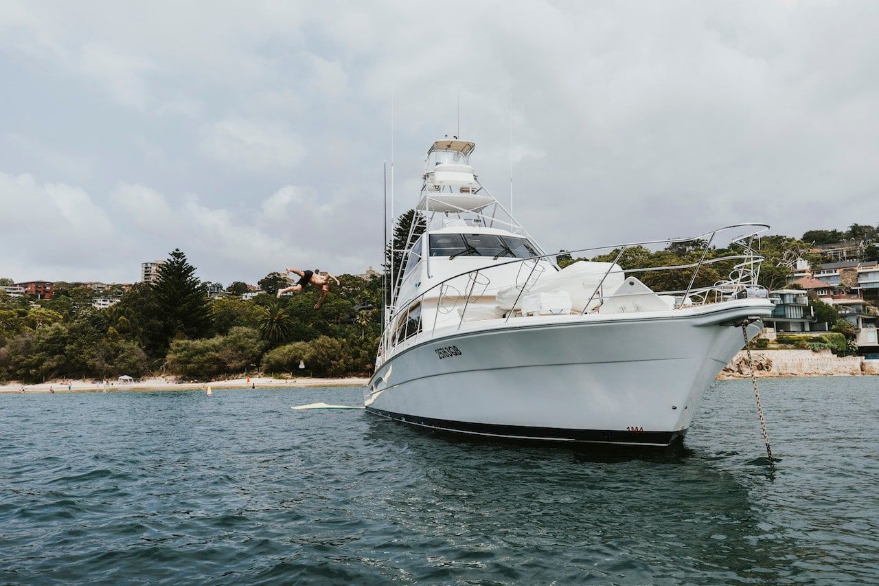 A large white boat is floating on top of a body of water.