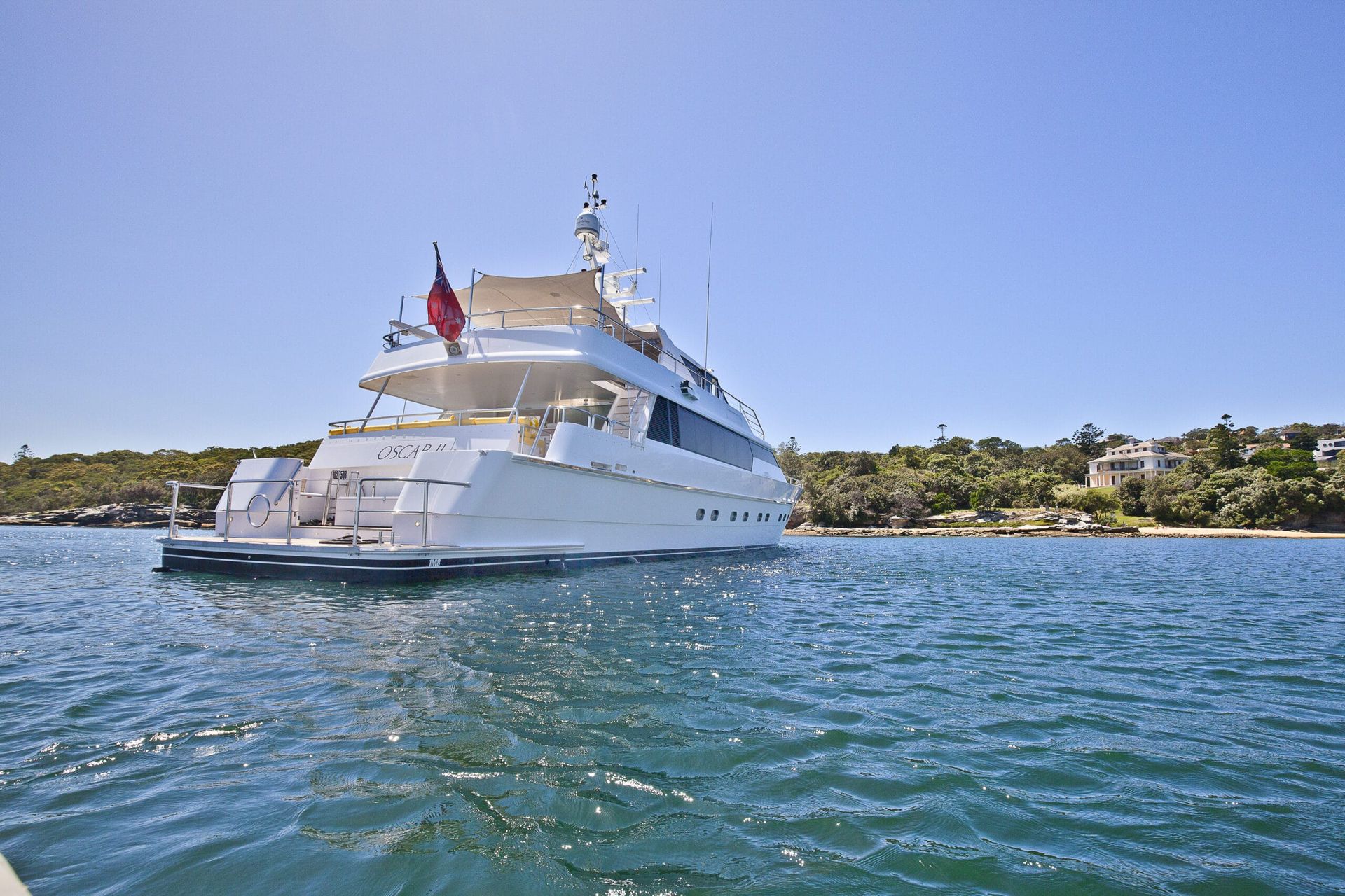 A large white yacht is floating on top of a body of water.