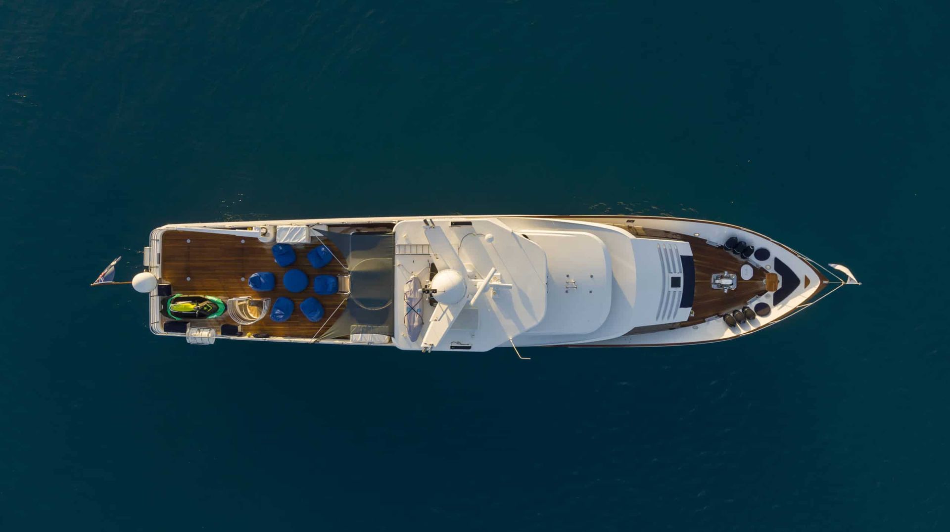 A large white yacht is floating on top of a large body of water.