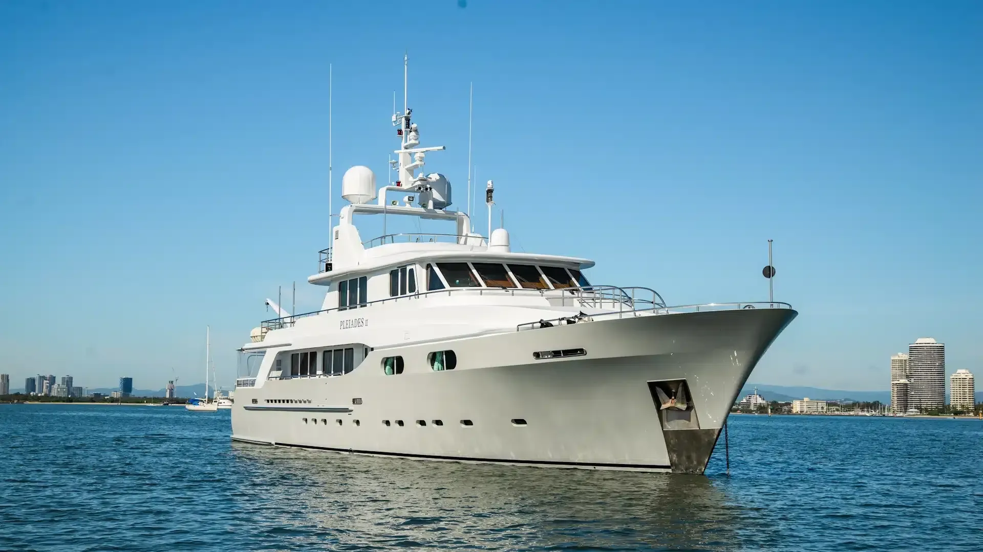 A large white yacht is floating on top of a body of water.