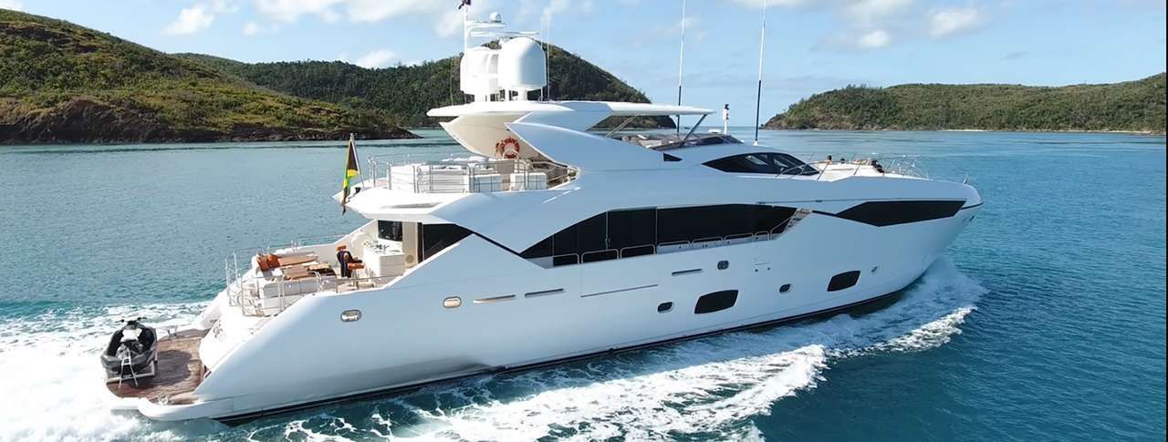 A large white yacht is floating on top of a body of water.