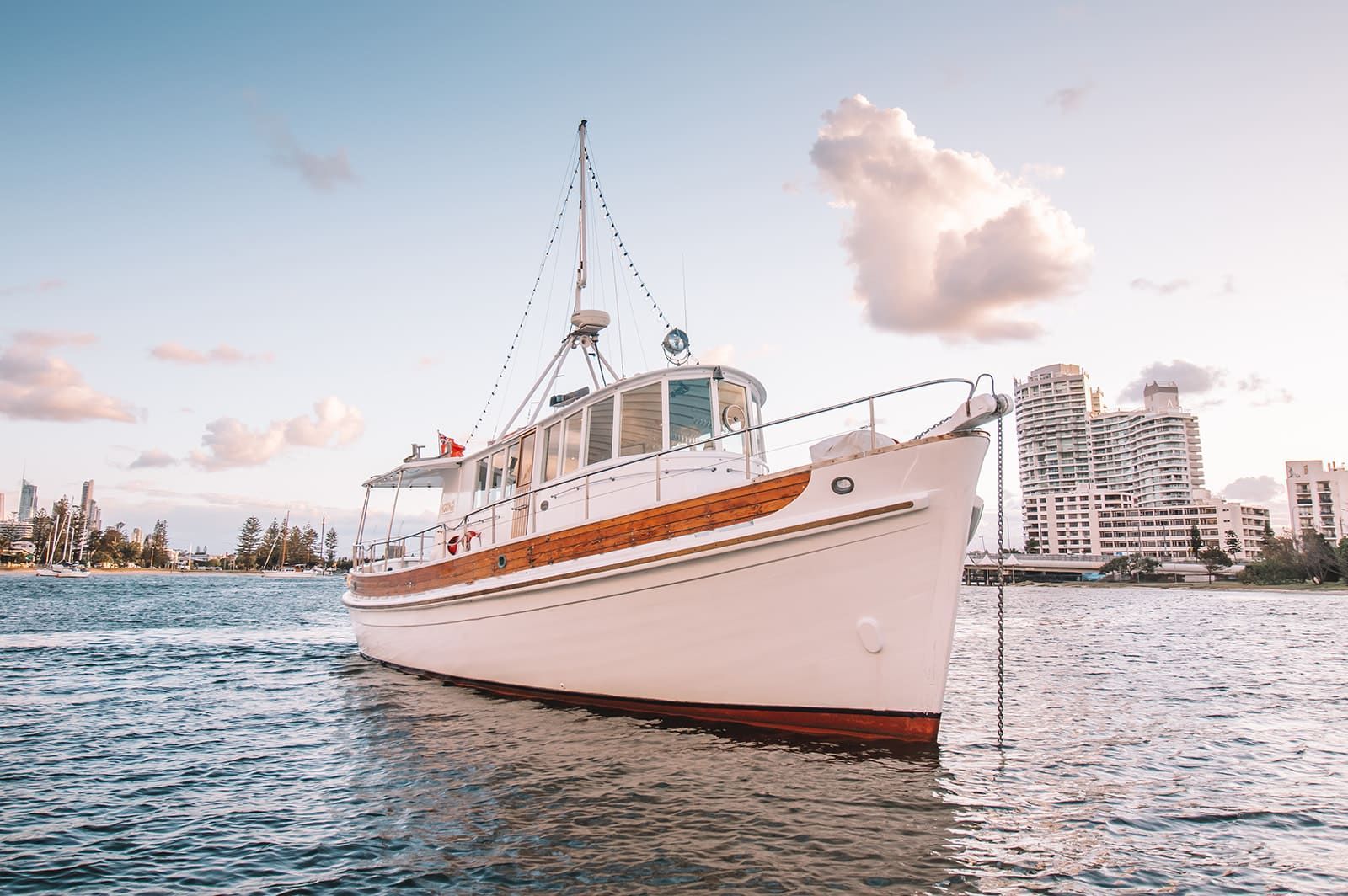 A white boat is floating on top of a body of water.