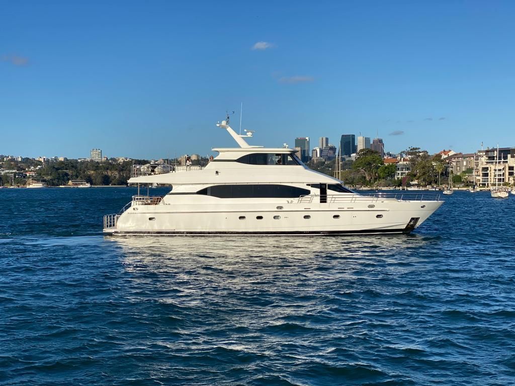 A large white yacht is floating on top of a body of water.