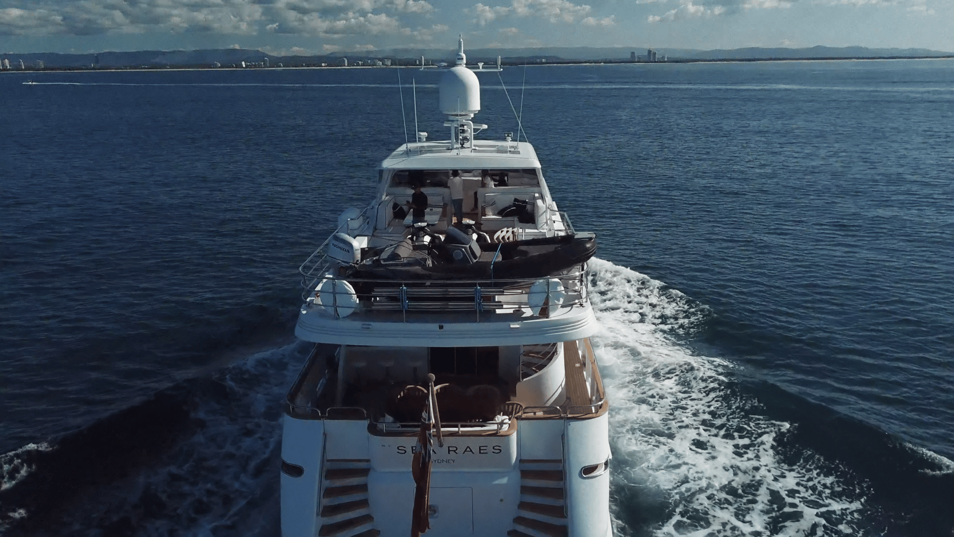 A large white yacht is floating on top of a body of water.