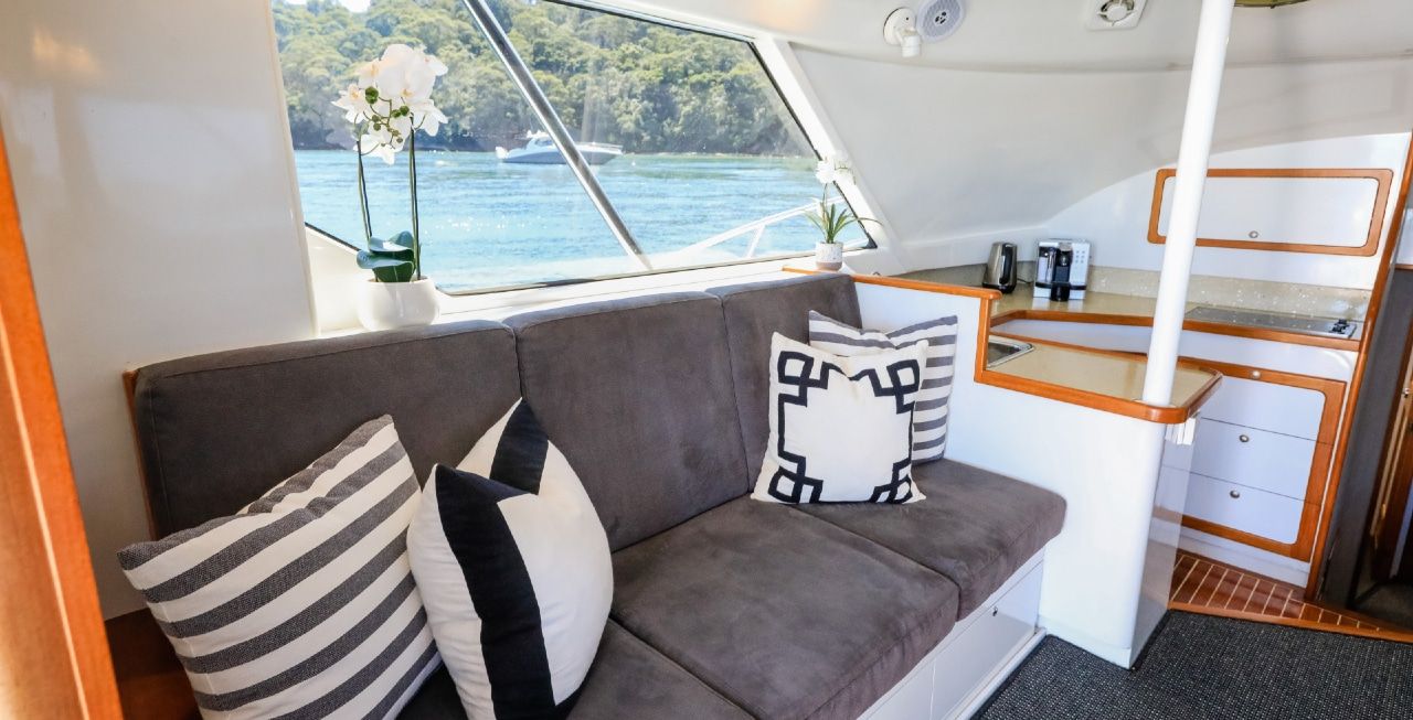 A white boat is floating on top of a body of water.