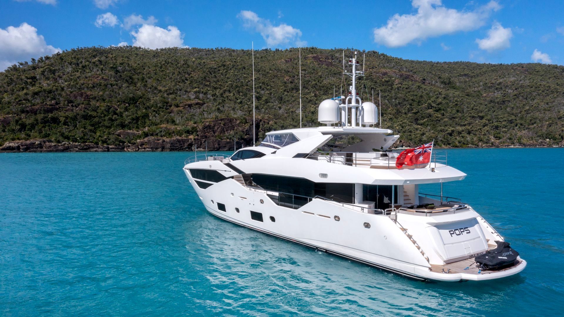 A Large White Yacht Docked Near an Island — Club Nautical in Gold Coast, QLD