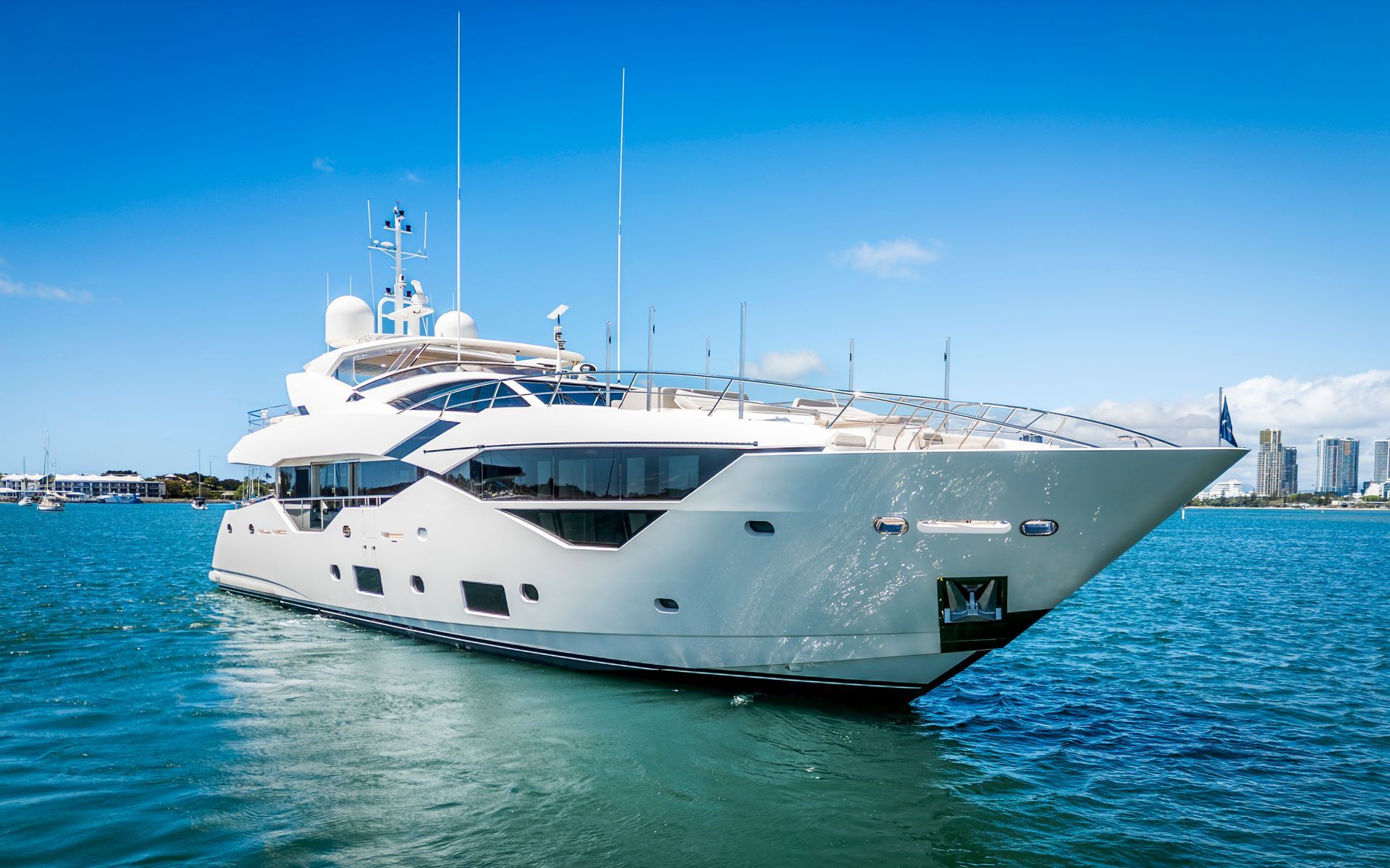 A large white yacht is floating on top of a body of water.