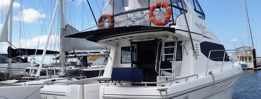 A large white boat is floating on top of a body of water.