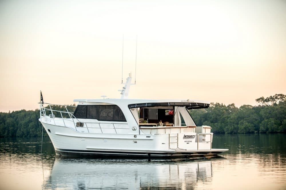 A large white boat is floating on top of a body of water.