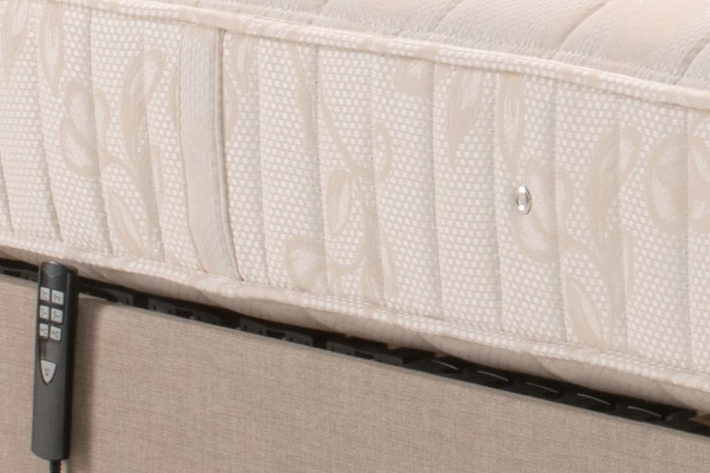 A mattress with a remote control attached to it.