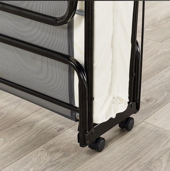 A folding bed with wheels is sitting on a wooden floor | Bedlam Beds Bristol