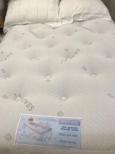 A bed with a mattress and pillows on it.