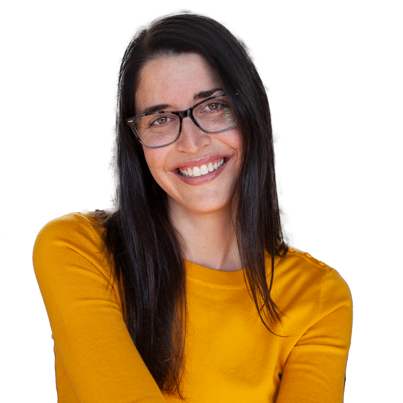 Smiling older woman with curly white hair, in white shirt, hand near neck, isolated.