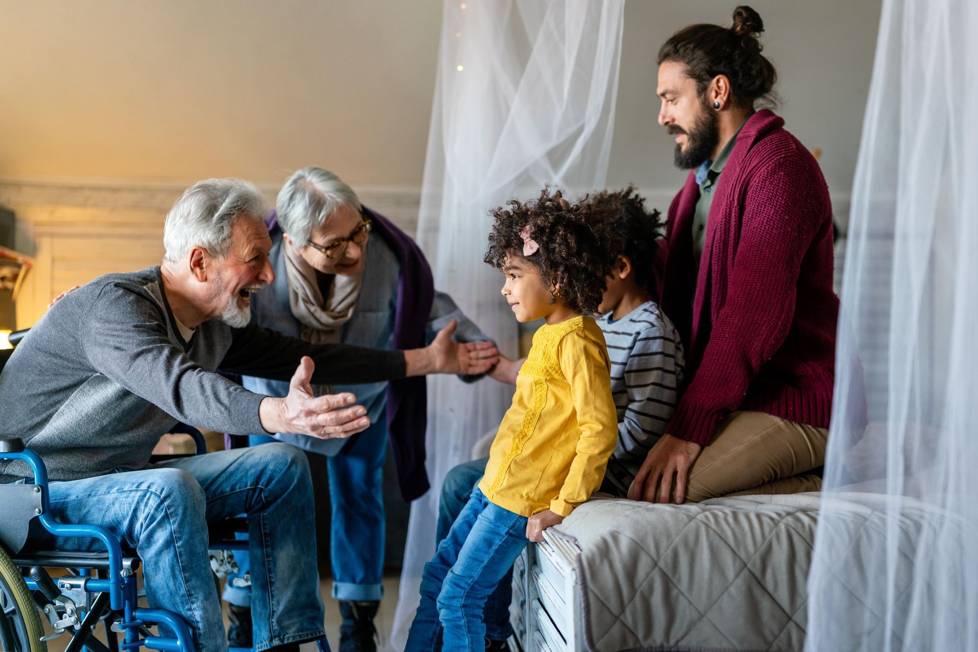 Woman comforts elderly woman, both smiling and touching foreheads.