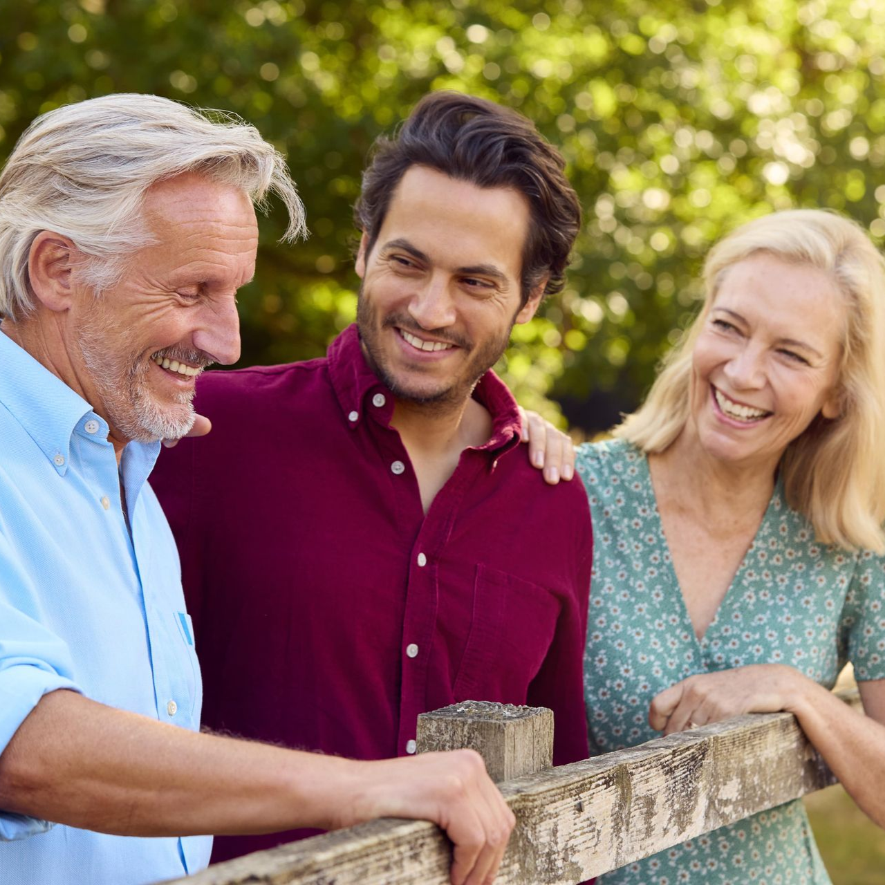 Woman with glasses smiling while reading a book. Red background.