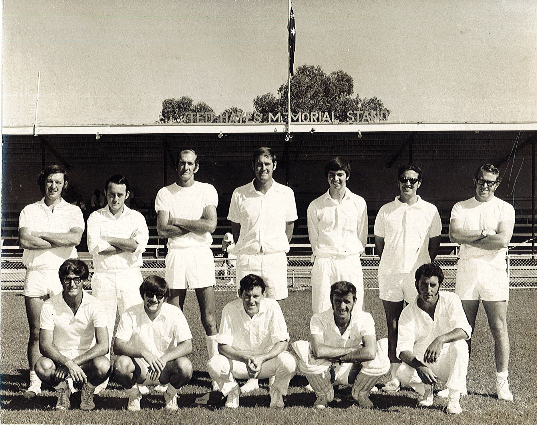 A black and white photo of a group of men in white shirts