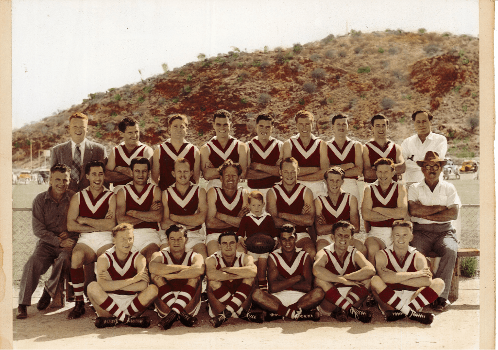A group of men are posing for a picture with their arms crossed