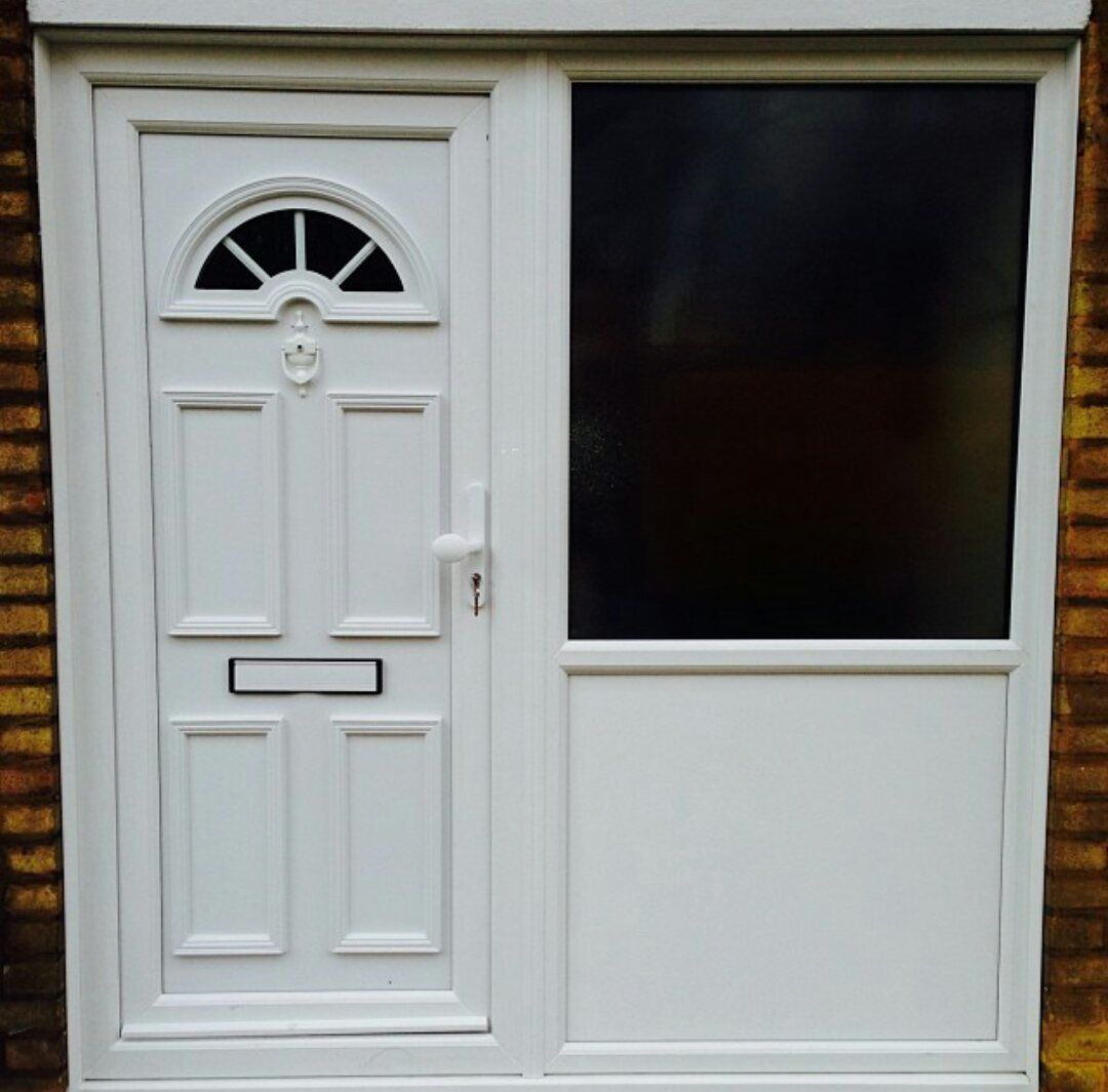 A white door with a window and a mail slot