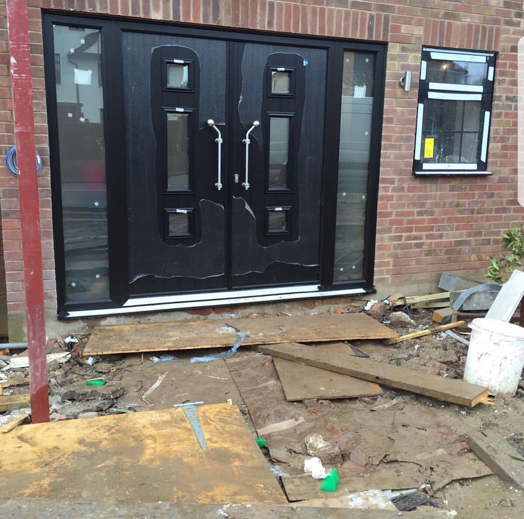 A brick building with a black door and a window